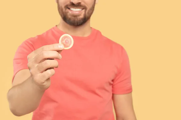 Man Holding Condom Beige Background Closeup Space Text Safe Sex — Stock Photo, Image