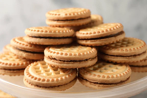 stock image Tasty sandwich cookies with cream on tray, closeup