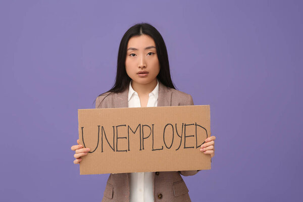 Asian woman holding sign with word Unemployed on purple background