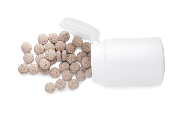 stock image Plastic jar with brewer's yeast tablets isolated on white, top view