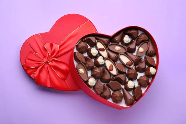 Caixa Forma Coração Com Deliciosos Doces Chocolate Fundo Lilás Vista — Fotografia de Stock