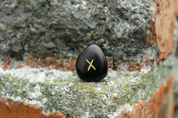 stock image Black rune Gebo on stone outdoors, closeup