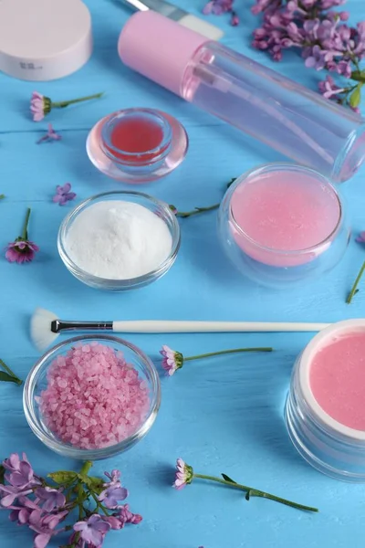 stock image Homemade cosmetic products and fresh ingredients on light blue wooden table, above view