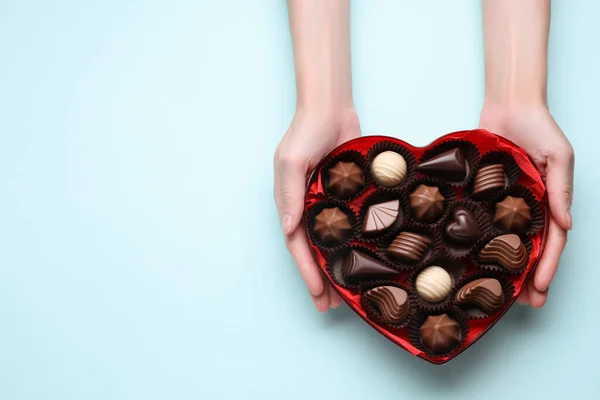 Woman Holding Heart Shaped Box Delicious Chocolate Candies Light Blue — Stock Photo, Image