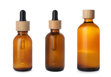 Beyaz arka planda şişelerde farklı kozmetik yağlar var.