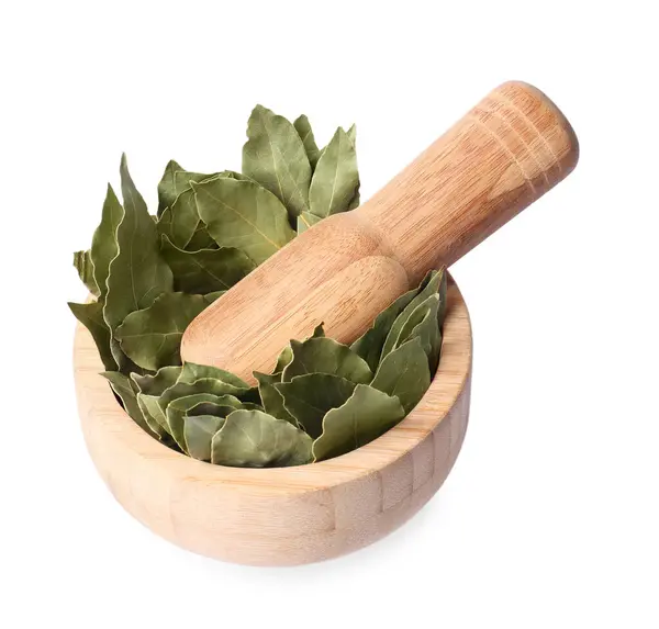 stock image Wooden mortar with aromatic bay leaves and pestle isolated on white