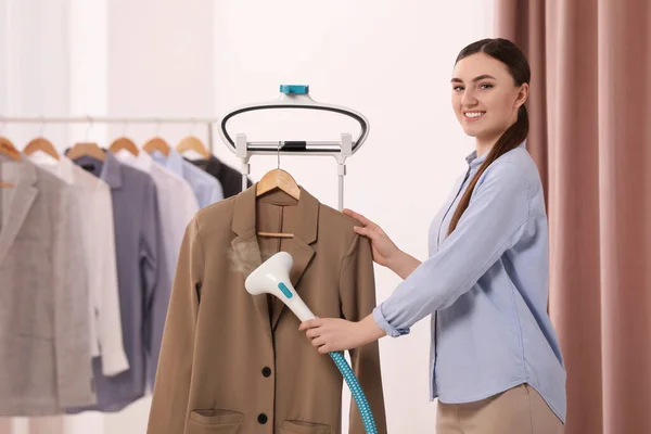Woman Steaming Jacket Hanger Room — 스톡 사진