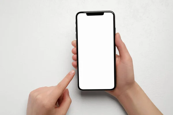 Woman Holding Smartphone Blank Screen White Table Top View Mockup — Stock Photo, Image