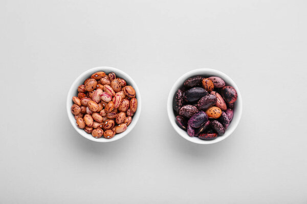 Different kinds of kidney beans on white background, top view