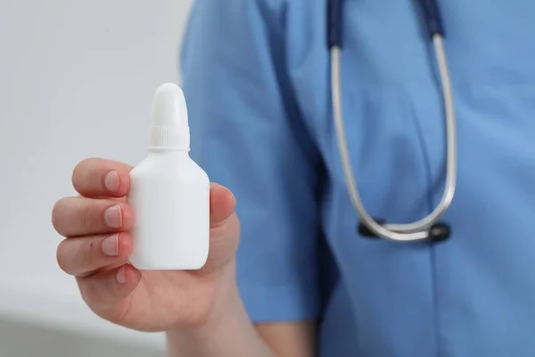 stock image Doctor holding nasal spray on white background, closeup