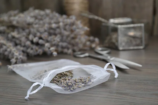 stock image Scented sachet with dried lavender flowers on wooden table, closeup