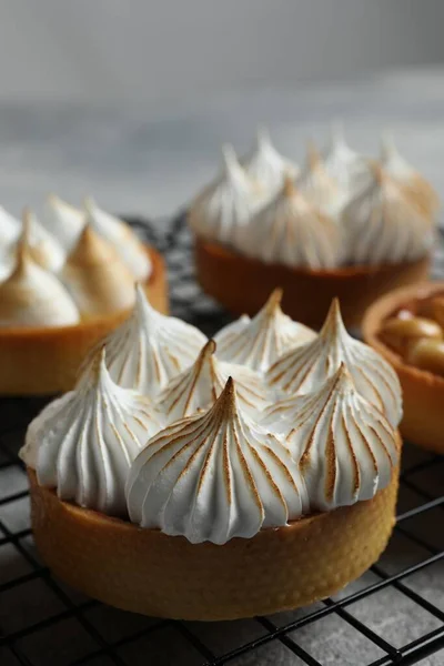 stock image Many different tartlets on cooling tray, closeup. Tasty dessert