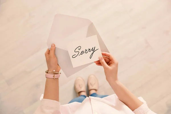 Woman Receiving Apology Message Indoors Top View Card Word Sorry — Stock Photo, Image