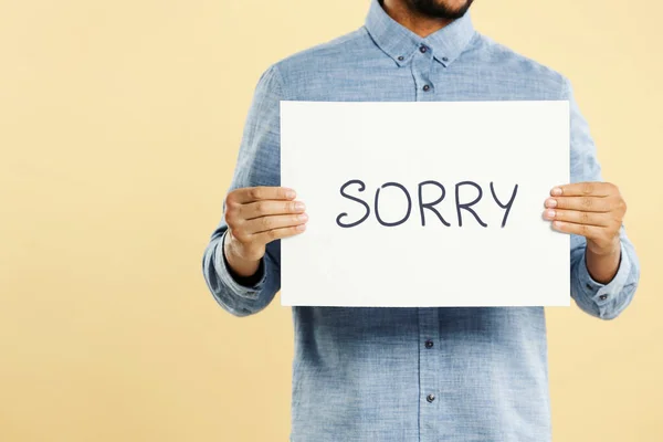 Apology Man Holding Card Word Sorry Beige Background Closeup — Stock Photo, Image