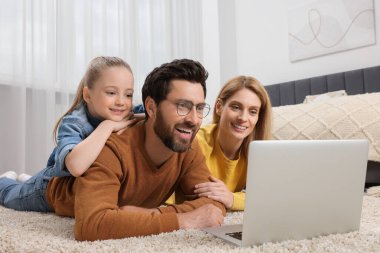 Evde dizüstü bilgisayarı olan mutlu bir aile