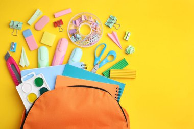 Flat lay composition with different school stationery on yellow background. Back to school