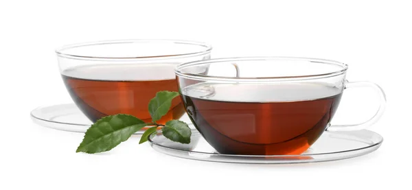 Glasbecher Mit Heißem Aromatischen Tee Und Grünen Blättern Auf Weißem — Stockfoto