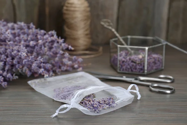 stock image Scented sachet with dried lavender flowers on wooden table