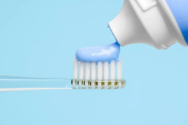 Squeezing Toothpaste Electric Toothbrush Light Blue Background Closeup — Stock Photo, Image