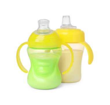 Feeding bottles with milk on white background