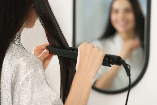 Woman Using Hair Iron Mirror Indoors Closeup Space Text — Stock Photo, Image