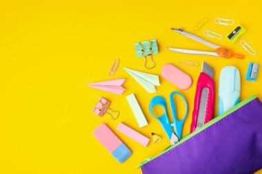 Flat lay composition with different school stationery on yellow background, space for text. Back to school