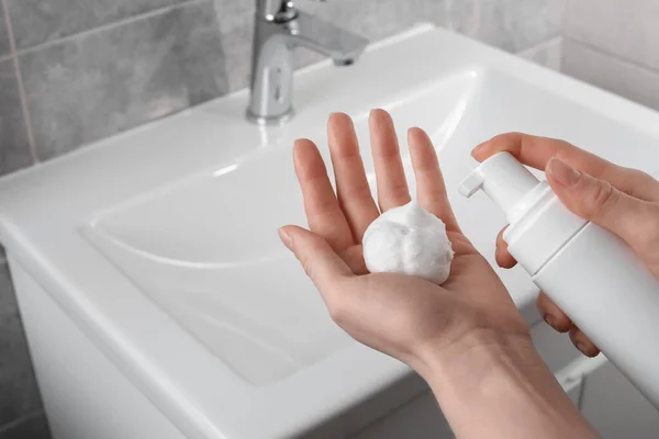 stock image Woman washing hands with cleansing foam near sink in bathroom, closeup. Space for text