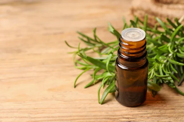 Bottle Essential Oil Fresh Rosemary Wooden Table Space Text — Stock Photo, Image