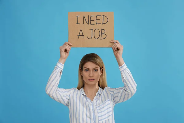 Unemployed Woman Holding Sign Phrase Need Job Light Blue Background — Stock Photo, Image