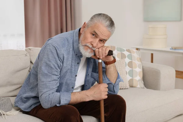 Senior Man Walking Cane Sitting Sofa Home — Stock Photo, Image