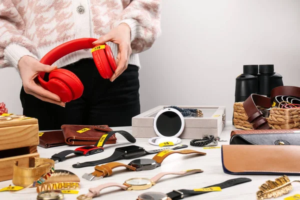 Woman Holding Headphones Table Different Stuff Indoors Closeup Garage Sale — Stock Photo, Image