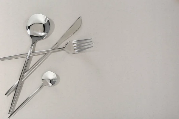 stock image Stylish cutlery set on light grey background, flat lay. Space for text