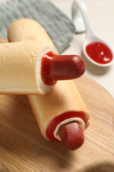 stock image Tasty french hot dogs and dip sauce on wooden board, closeup