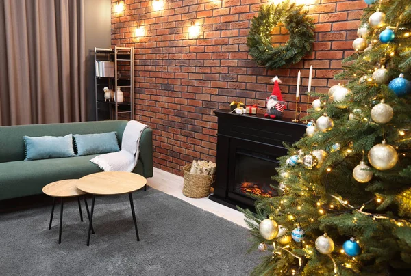 Beautiful tree with festive lights and Christmas decor in living room. Interior design