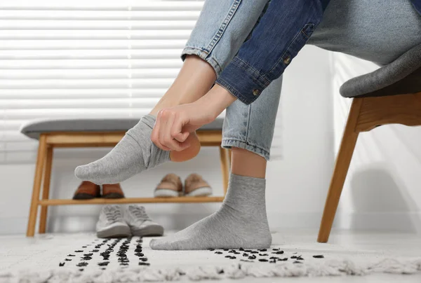 Woman Putting Grey Socks Home Closeup — 图库照片