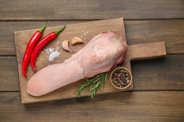 stock image Raw beef tongue, peppercorns, garlic, salt, rosemary and chili peppers on wooden table, top view