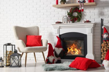 Beautiful Christmas themed photo zone with armchair and fireplace in room