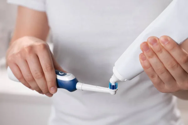 Woman Squeezing Toothpaste Tube Electric Toothbrush Closeup — Stock Photo, Image