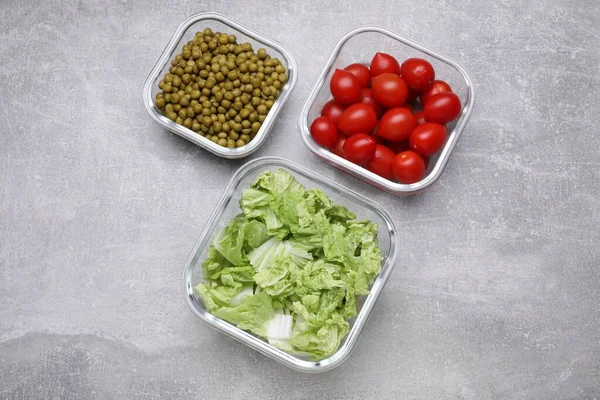 stock image Glass containers with different fresh products on light grey table, flat lay