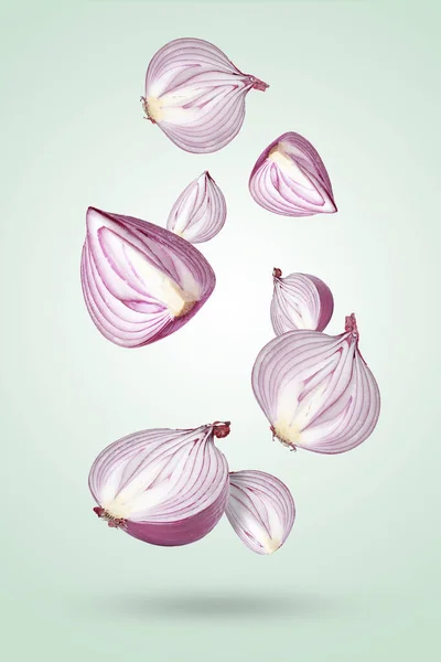 Cut Red Onions Falling Light Blue Background — Stock Photo, Image