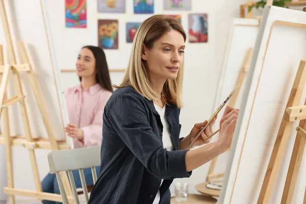 Women attending painting class in studio. Creative hobby