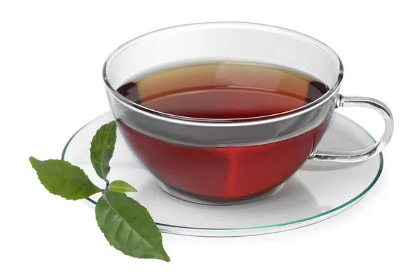 白い背景に熱い芳香のお茶と緑の葉のガラスカップ — ストック写真