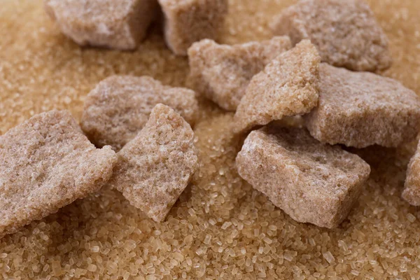 Refined and granulated brown sugar as background, closeup