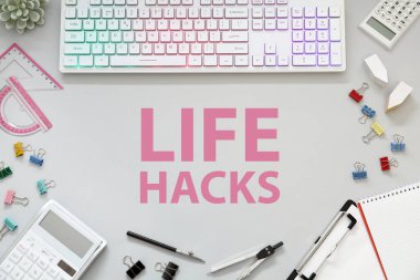 Beyaz masadaki Hayat Hackleri, bilgisayar klavyesi ve kırtasiyesi olan İşyeri, düz konum
