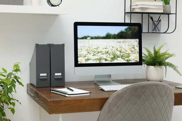 自宅で木製の机の上のコンピュータと居心地の良いワークスペース — ストック写真