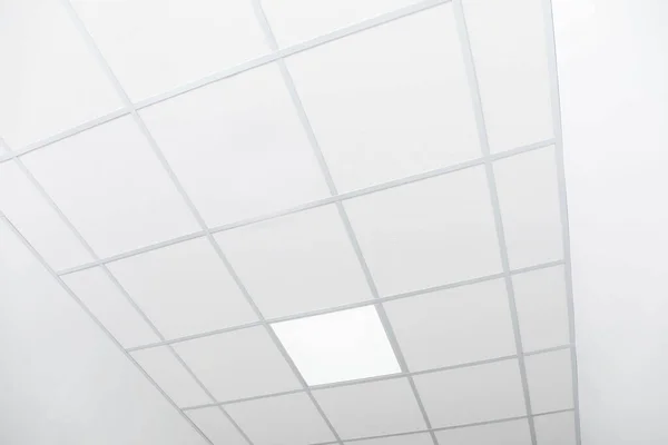 stock image White ceiling with modern lighting in office