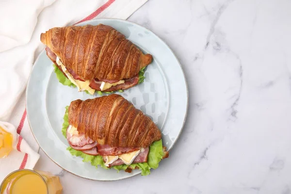 stock image Tasty croissants with brie cheese, ham and bacon on white marble table, flat lay. Space for text