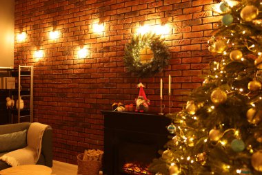 Beautiful tree with festive lights and Christmas decor in living room. Interior design