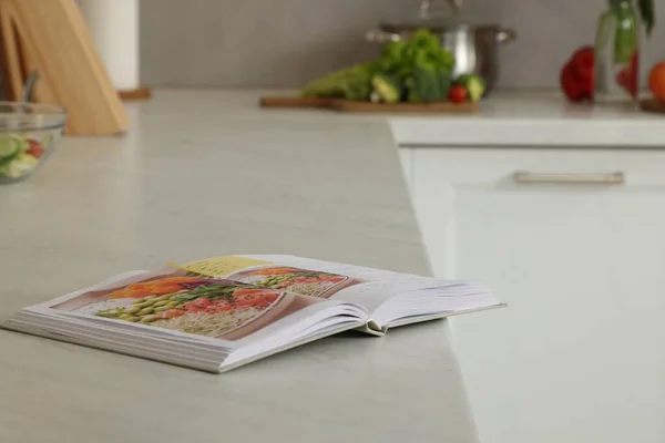 Libro de recetas en blanco en la mesa de la cocina Fotografía de
