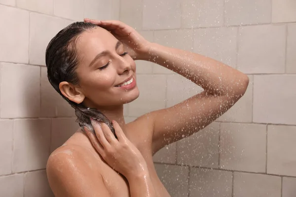 Happy Woman Washing Hair While Taking Shower Home — стоковое фото